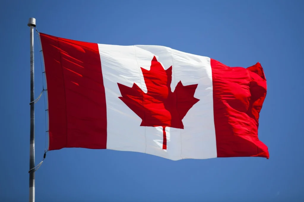 Canadian flag waving proudly, symbolizing opportunity and growth for Canadian businesses.